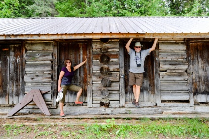 A couple pose near a log cabin on Clearwater River.