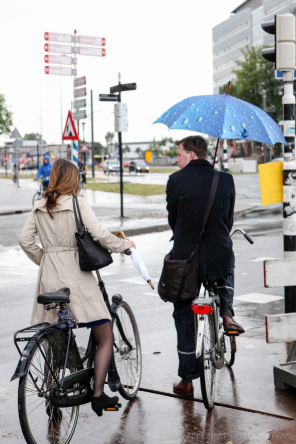 A couple stops at a light while cycling in the rain in Utrecht, Netherlands.
