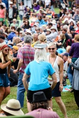 A man blanaces a book on his head while dancing at the Folk Festival.